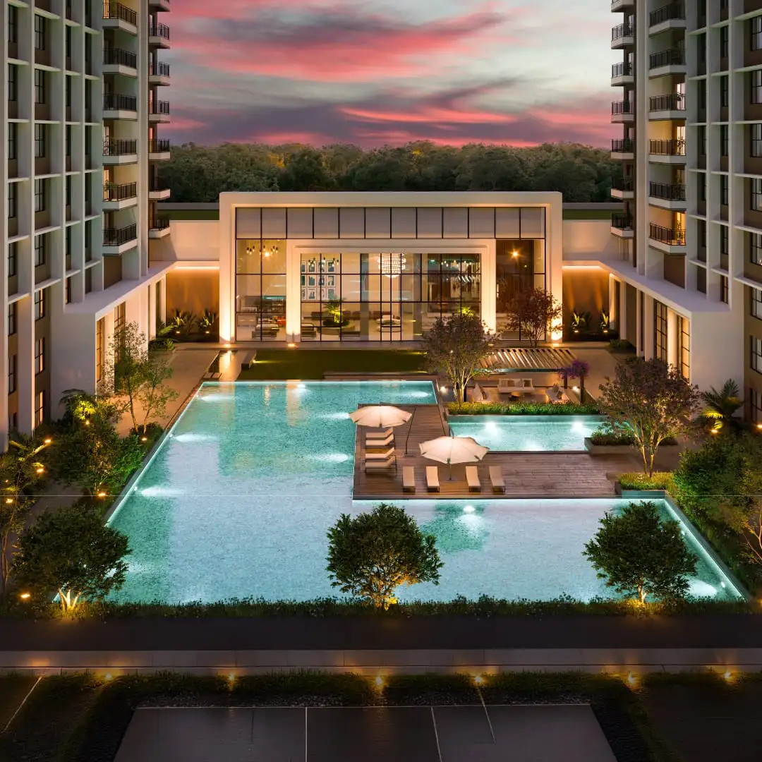 Sobha Bellevue clubhouse pool deck at dusk between the twin towers